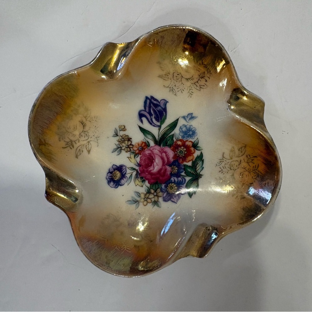 Vintage gold trimmed porcelain ashtray with floral pattern